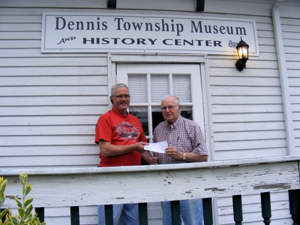 Don accepts check from Tom Champion